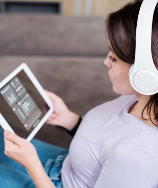 Young Woman In Headphones Looking At Remote 4zg96t5 Jpg